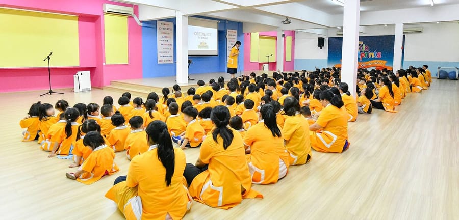 Pupils seated in the assembly hall